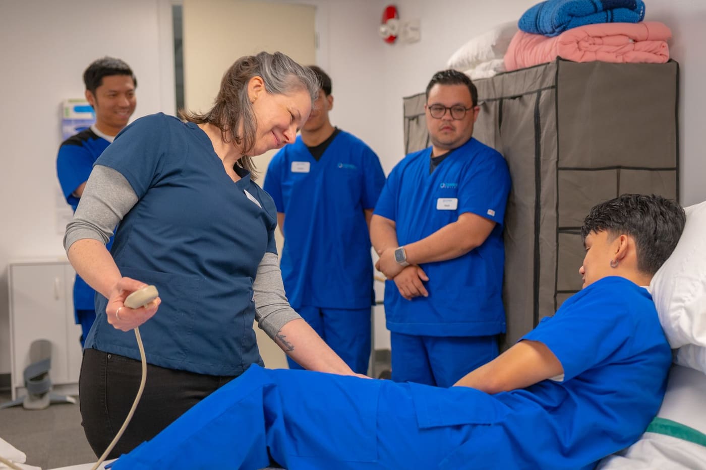Healthcare professionals participating in a supervised equipment training session